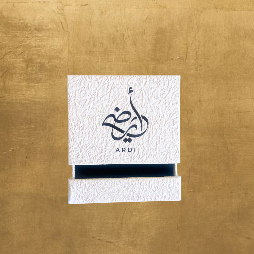 White card with black Arabic calligraphy and 'ARDI' branding on a gold background