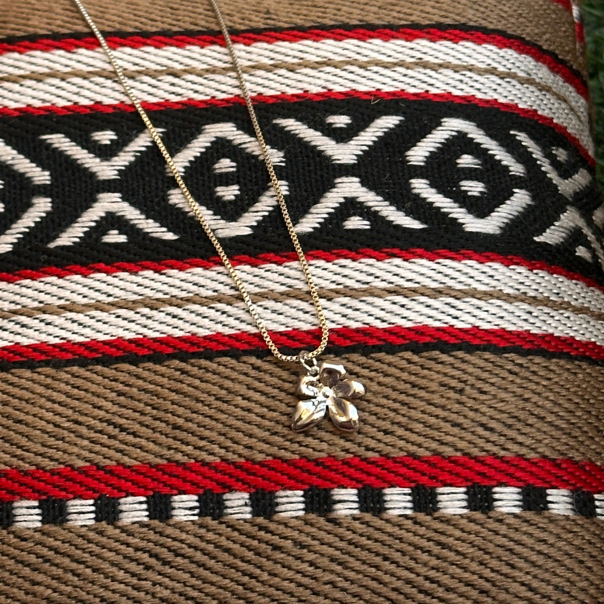 Necklace with a pendant on a woven fabric background