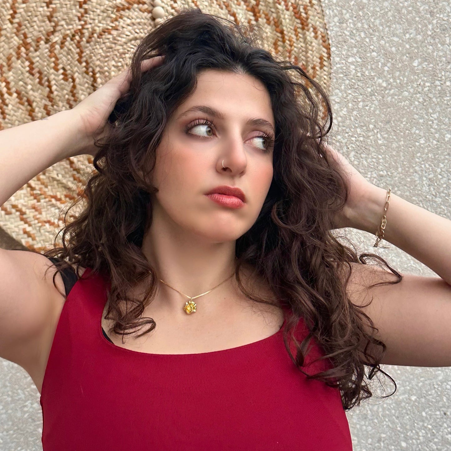 Woman in a red top with a decorative background