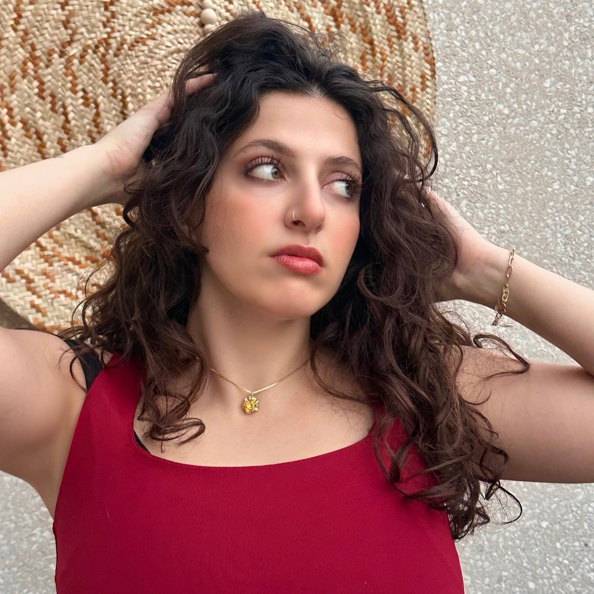Woman in a red top with a decorative background